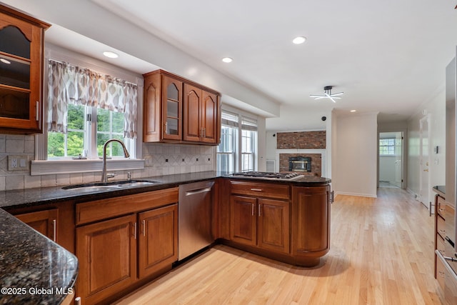 11 Boylston Dr, Bethlehem, NY 12054 - kitchen with stainless steel appliances, healthy amount of natural light, a brick fireplace, brown cabinetry, and recessed lighting