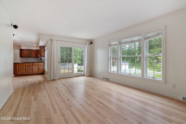 11 Boylston Dr, Bethlehem, NY 12054 - unfurnished living room with light wood-style flooring and crown molding