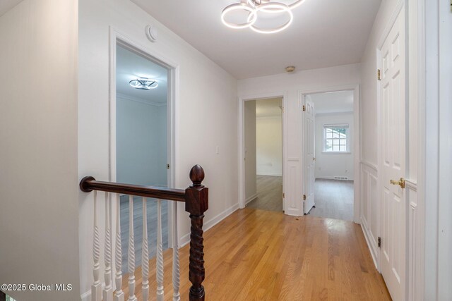11 Boylston Dr, Bethlehem, NY 12054 - hallway featuring wood finished floors and a chandelier