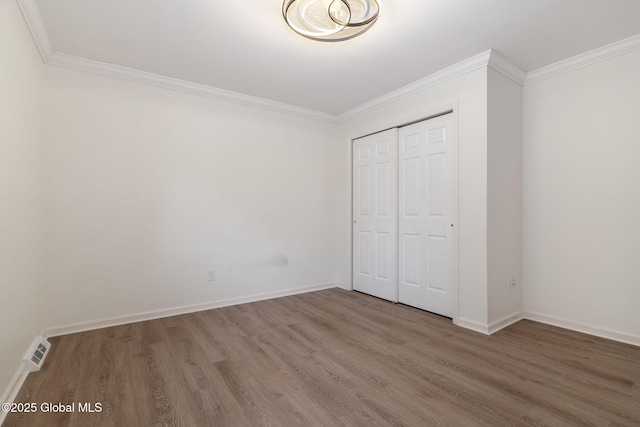 11 Boylston Dr, Bethlehem, NY 12054 - unfurnished bedroom with wood finished floors, ornamental molding, and a closet