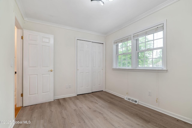 11 Boylston Dr, Bethlehem, NY 12054 - unfurnished bedroom featuring light wood-type flooring, ornamental molding, and a closet