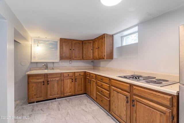 11 Boylston Dr, Bethlehem, NY 12054 - kitchen with stainless steel electric cooktop, light marble finish floors, brown cabinetry, and light countertops