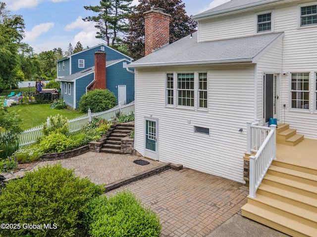 11 Boylston Dr, Bethlehem, NY 12054 - back of property with a patio, a chimney, and roof with shingles