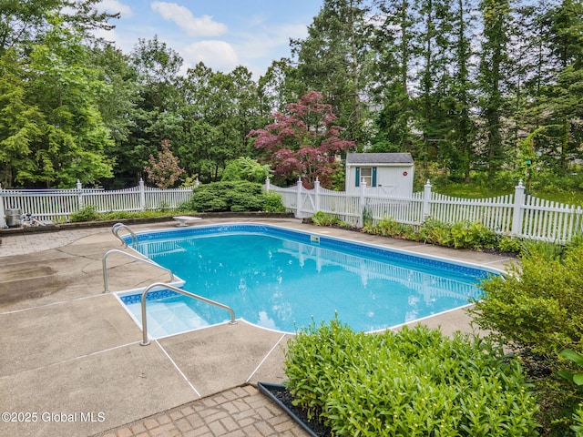 11 Boylston Dr, Bethlehem, NY 12054 - view of swimming pool with a patio area, a fenced backyard, view of scattered trees, and an outbuilding