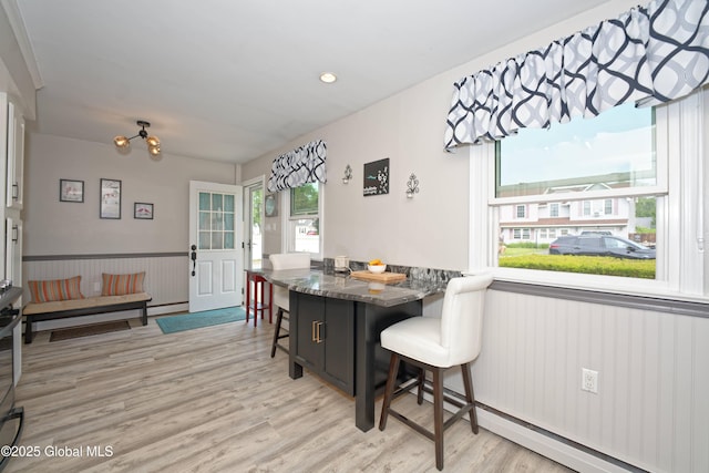 1038 Horvath St, Schenectady, NY 12303 - dining area with healthy amount of natural light, light wood-style floors, a wainscoted wall, and a chandelier