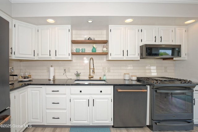 1038 Horvath St, Schenectady, NY 12303 - kitchen with stainless steel appliances, dark countertops, white cabinetry, tasteful backsplash, and recessed lighting