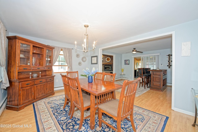1038 Horvath St, Schenectady, NY 12303 - dining area with a baseboard radiator, a chandelier, light wood-type flooring, baseboard heating, and a ceiling fan