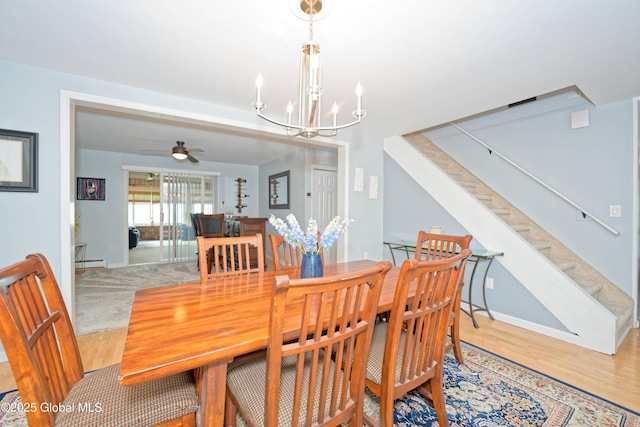 1038 Horvath St, Schenectady, NY 12303 - dining room featuring a chandelier, wood finished floors, ceiling fan, and stairway