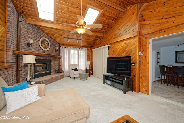 1038 Horvath St, Schenectady, NY 12303 - carpeted living area with a brick fireplace, vaulted ceiling, a skylight, wooden ceiling, and wooden walls