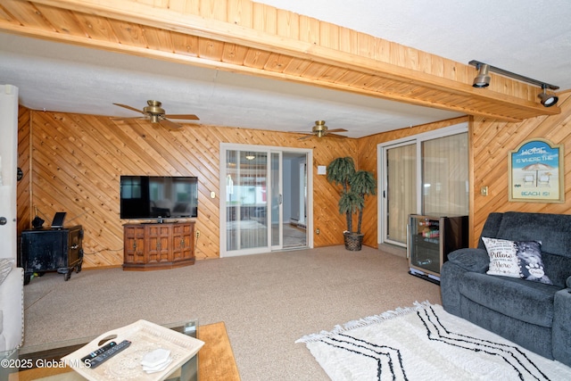 1038 Horvath St, Schenectady, NY 12303 - living area with ceiling fan, carpet floors, wood walls, beverage cooler, and beamed ceiling