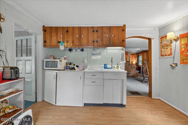 579 Camden Valley Rd, Salem, NY 12873 - kitchen with white microwave, light wood finished floors, crown molding, light countertops, and arched walkways