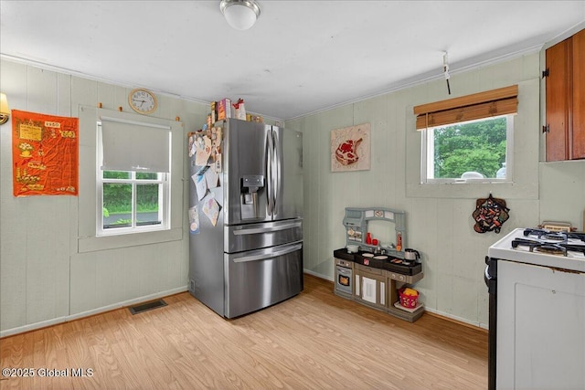579 Camden Valley Rd, Salem, NY 12873 - kitchen with stainless steel fridge with ice dispenser, light wood-style flooring, white gas range oven, and crown molding