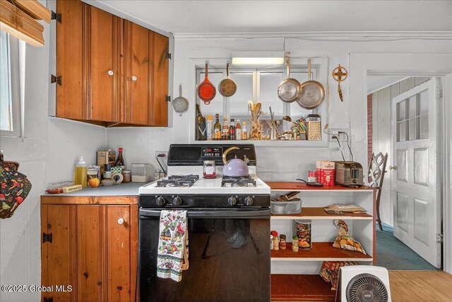 579 Camden Valley Rd, Salem, NY 12873 - kitchen with gas stove, brown cabinetry, and wood finished floors