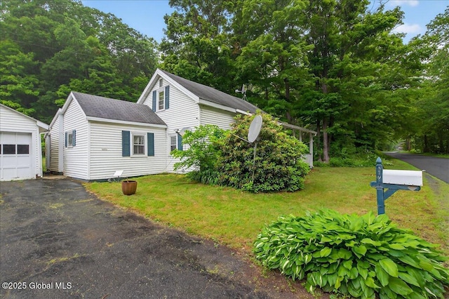 579 Camden Valley Rd, Salem, NY 12873 - view of side of property with an outdoor structure, a shingled roof, a yard, and asphalt driveway