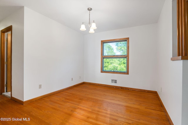 11 Drawbridge Dr, Guilderland, NY 12203 - spare room with a chandelier and light wood-type flooring