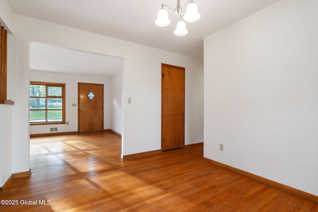 11 Drawbridge Dr, Guilderland, NY 12203 - empty room with light wood-type flooring and a chandelier