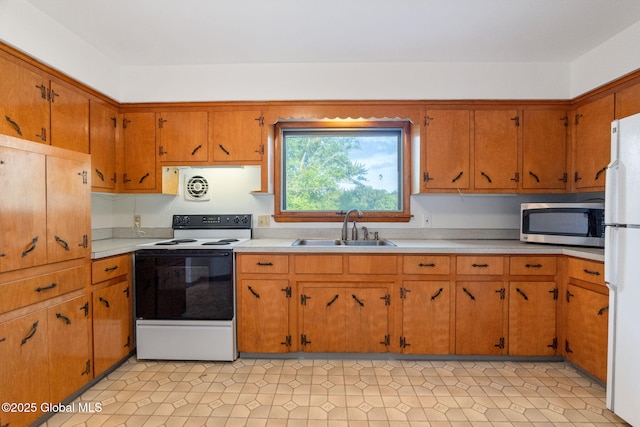 11 Drawbridge Dr, Guilderland, NY 12203 - kitchen with white appliances, light countertops, and brown cabinets