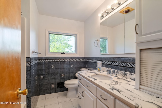 11 Drawbridge Dr, Guilderland, NY 12203 - bathroom with tile patterned flooring, vanity, a wainscoted wall, and tile walls
