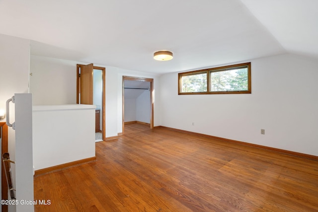 11 Drawbridge Dr, Guilderland, NY 12203 - unfurnished bedroom with wood finished floors, a closet, and vaulted ceiling