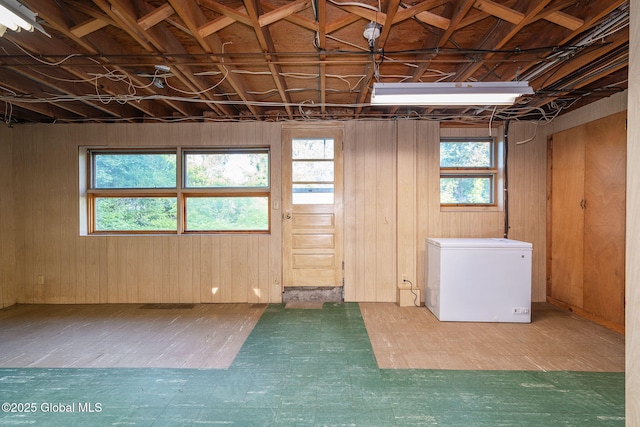 11 Drawbridge Dr, Guilderland, NY 12203 - basement featuring refrigerator, tile patterned floors, and wooden walls