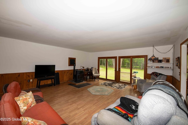 22 Elm Lane Ext, Westerlo, NY 12083 - living area featuring a wainscoted wall, a wood stove, wooden walls, and wood finished floors