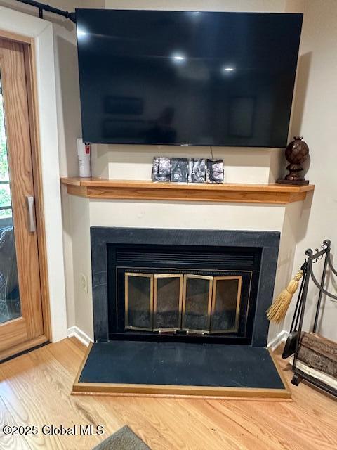 110 Sagamore Rd Unit 6B5, Bolton, NY 12814 - detailed view of a glass covered fireplace and wood finished floors