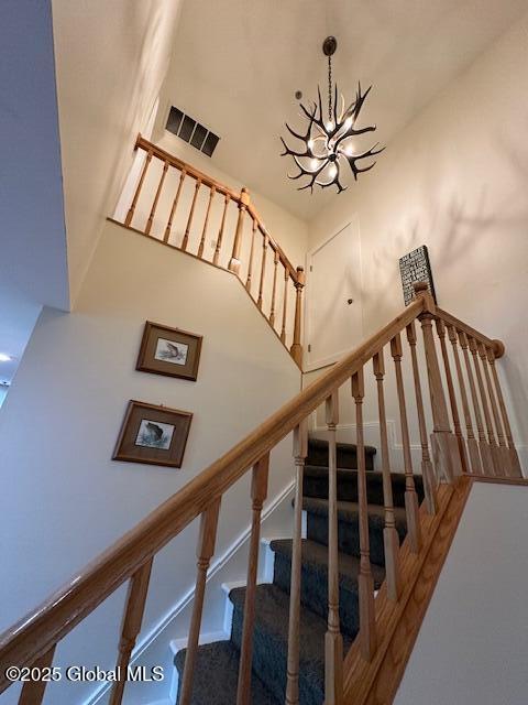 110 Sagamore Rd Unit 6B5, Bolton, NY 12814 - staircase featuring a chandelier
