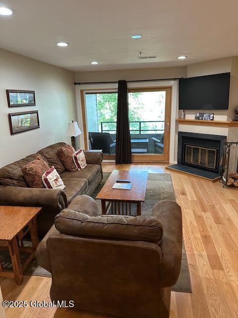 110 Sagamore Rd Unit 6B5, Bolton, NY 12814 - living area with light wood-type flooring, a glass covered fireplace, and recessed lighting