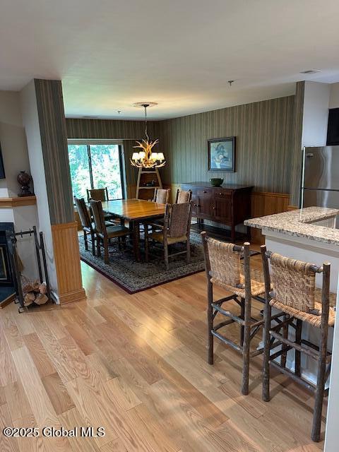 110 Sagamore Rd Unit 6B5, Bolton, NY 12814 - dining room with light wood-style floors and a chandelier