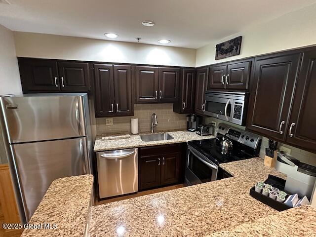 110 Sagamore Rd Unit 6B5, Bolton, NY 12814 - kitchen with stainless steel appliances, light stone counters, backsplash, and recessed lighting