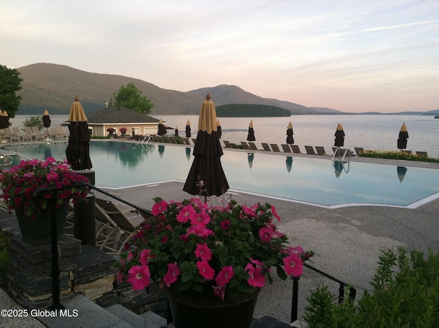 110 Sagamore Rd Unit 6B5, Bolton, NY 12814 - pool at dusk featuring a community pool and a water and mountain view