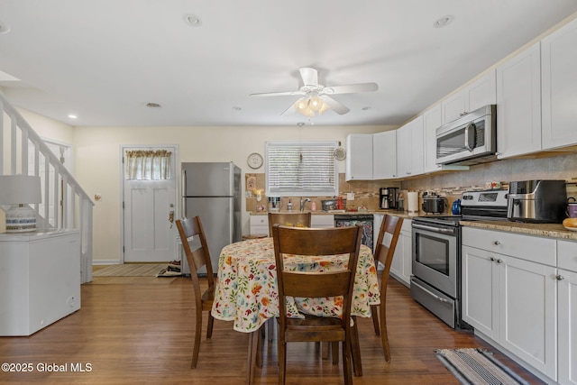 1148 Outer Dr, Rotterdam, NY 12303 - kitchen with appliances with stainless steel finishes, dark wood-style flooring, ceiling fan, white cabinetry, and recessed lighting