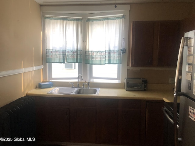 127 N Toll St, Scotia, NY 12302 - kitchen with freestanding refrigerator, light countertops, plenty of natural light, and range
