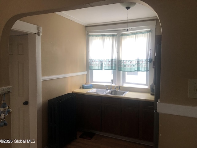 127 N Toll St, Scotia, NY 12302 - kitchen featuring radiator heating unit, healthy amount of natural light, arched walkways, and light countertops