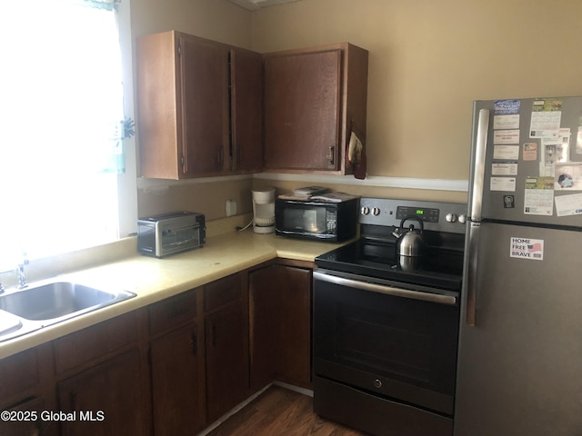 127 N Toll St, Scotia, NY 12302 - kitchen with appliances with stainless steel finishes, light countertops, and dark wood finished floors