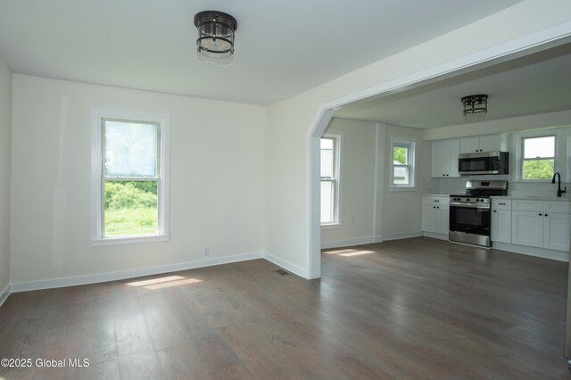 798 State Highway 29, Broadalbin, NY 12025 - unfurnished living room featuring dark wood-type flooring and arched walkways
