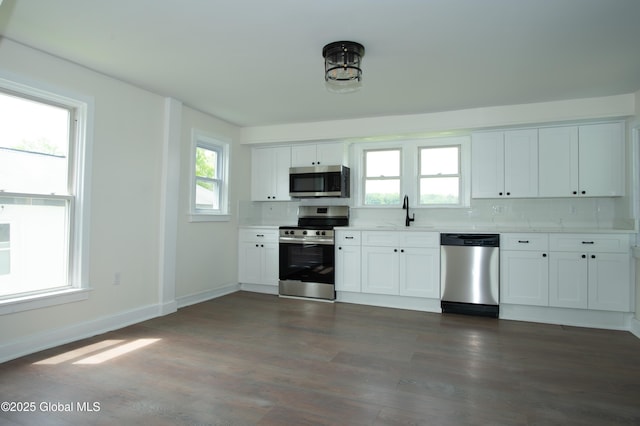 798 State Highway 29, Broadalbin, NY 12025 - kitchen featuring appliances with stainless steel finishes, light countertops, white cabinets, and decorative backsplash