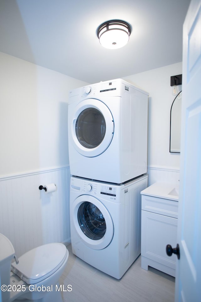 798 State Highway 29, Broadalbin, NY 12025 - laundry room with stacked washer / dryer and wainscoting