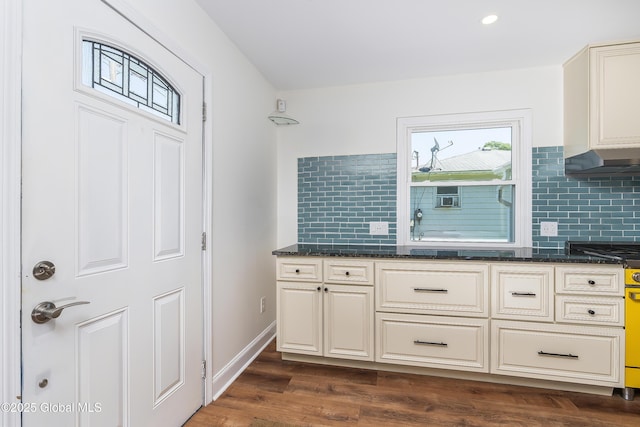 35 Magee Dr, Bethlehem, NY 12077 - kitchen featuring tasteful backsplash, dark wood-style flooring, dark stone counters, under cabinet range hood, and recessed lighting