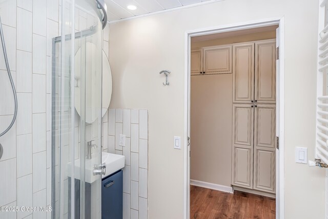 35 Magee Dr, Bethlehem, NY 12077 - bathroom with a towel warmer, a stall shower, wood finished floors, and recessed lighting