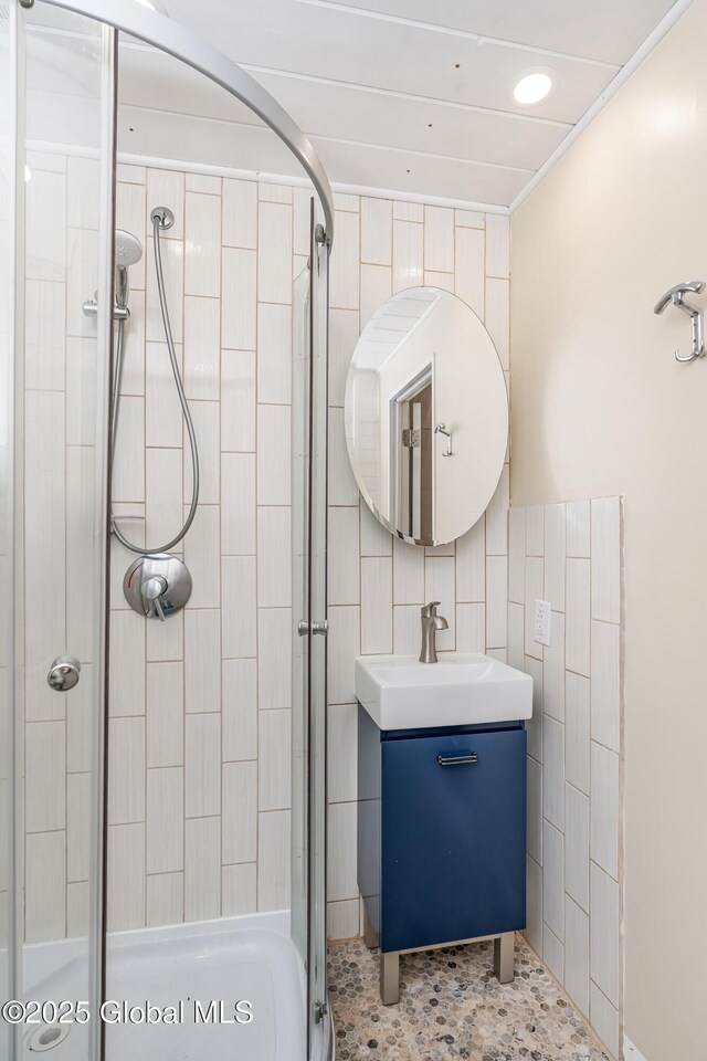 35 Magee Dr, Bethlehem, NY 12077 - bathroom featuring a shower stall, tile walls, and vanity