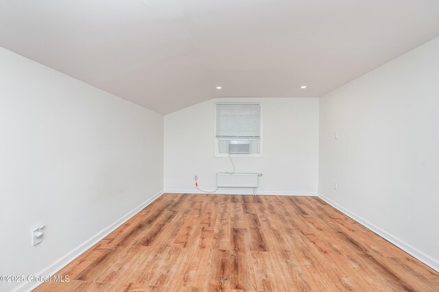 35 Magee Dr, Bethlehem, NY 12077 - bonus room featuring cooling unit, radiator heating unit, light wood-style floors, vaulted ceiling, and recessed lighting