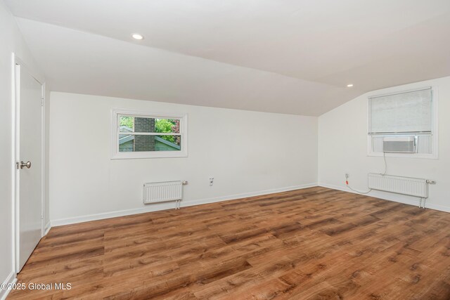 35 Magee Dr, Bethlehem, NY 12077 - bonus room featuring radiator heating unit, vaulted ceiling, wood finished floors, recessed lighting, and cooling unit