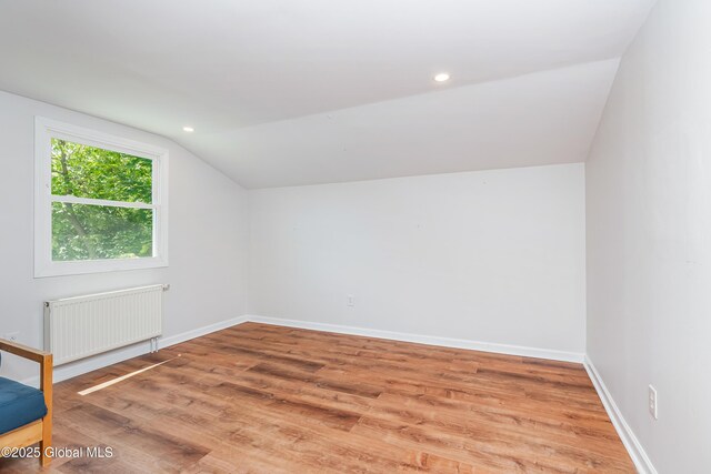 35 Magee Dr, Bethlehem, NY 12077 - bonus room with radiator heating unit, vaulted ceiling, wood finished floors, and recessed lighting