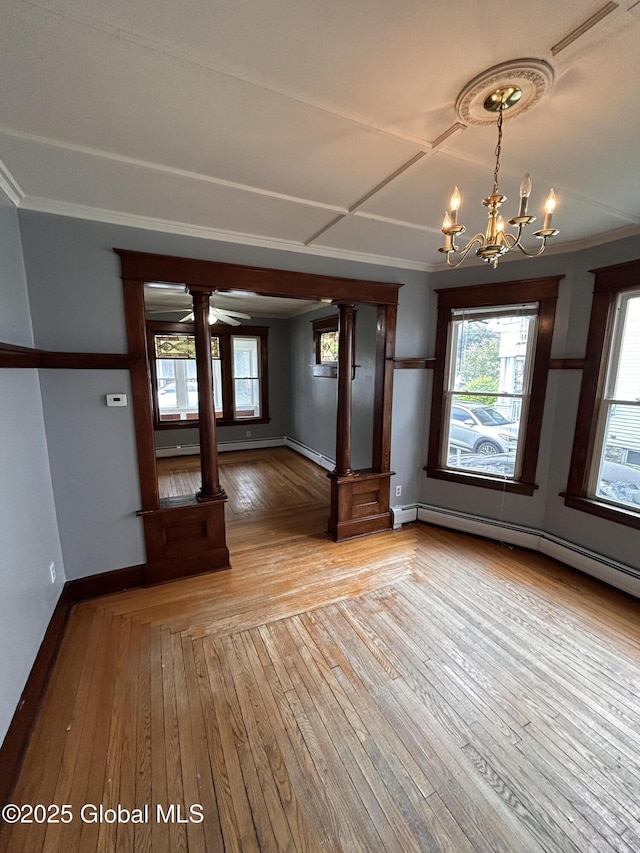 528 Harrison Ave, Schenectady, NY 12306 - unfurnished dining area featuring decorative columns, wood-type flooring, a chandelier, a baseboard heating unit, and ornamental molding