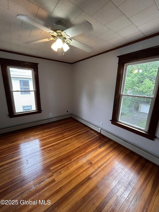 528 Harrison Ave, Schenectady, NY 12306 - empty room featuring plenty of natural light, hardwood / wood-style flooring, ornamental molding, and a ceiling fan