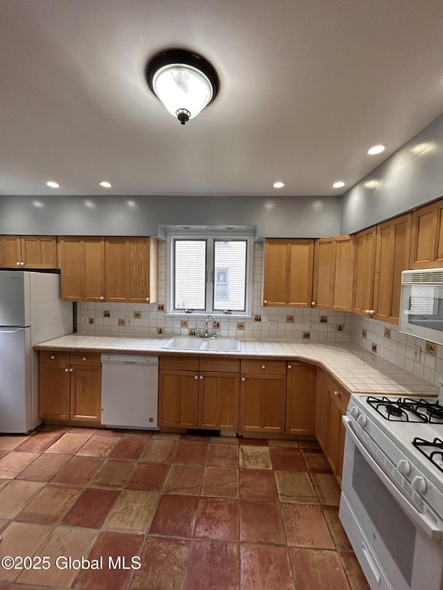 528 Harrison Ave, Schenectady, NY 12306 - kitchen featuring white appliances, tile countertops, decorative backsplash, stone finish floors, and recessed lighting