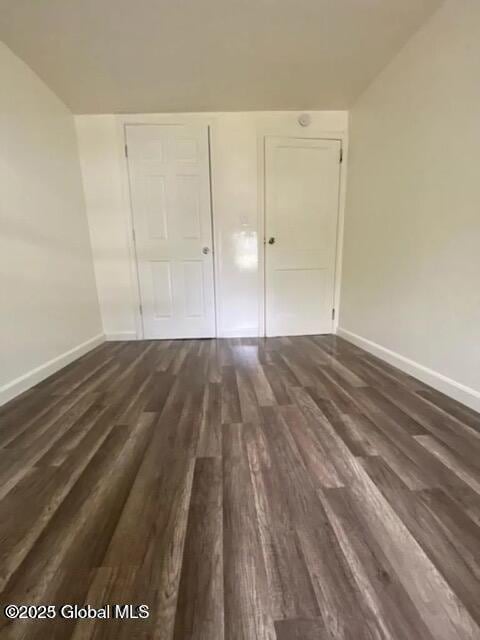18 Railroad Ave, Berlin, NY 12022 - unfurnished bedroom with dark wood-style flooring and baseboards