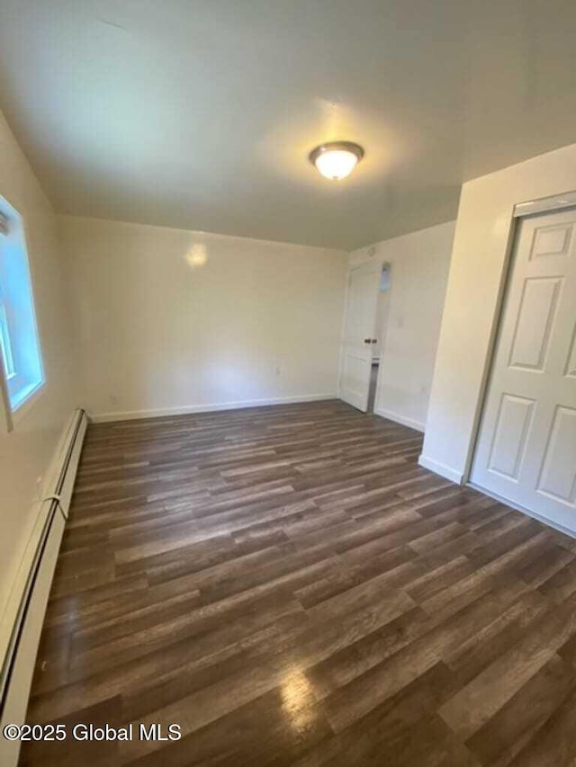 18 Railroad Ave, Berlin, NY 12022 - unfurnished bedroom featuring a baseboard heating unit and dark wood-style flooring