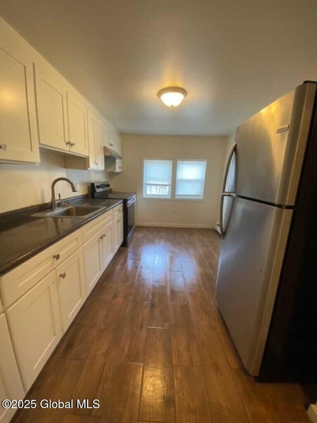 18 Railroad Ave, Berlin, NY 12022 - kitchen with freestanding refrigerator, electric range, dark countertops, dark wood-type flooring, and white cabinetry